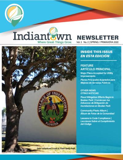 Newsletter cover with an image of the Village seal painted on a wall of a park structure